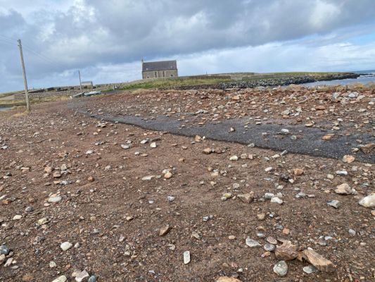 stormy-weather-leaves-whalsay-road-showered-with-stones